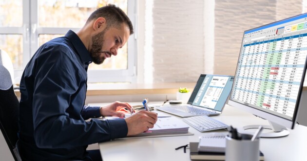 Analyst Working With Spreadsheet On Computer Screen