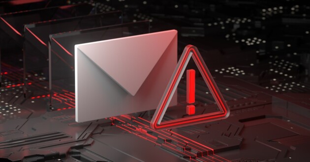 A white envelope and a red triangle with red exclamation point inside standing on a red circuit board