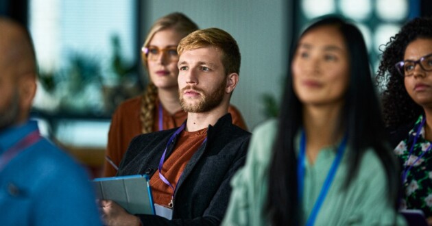 Diverse audience sitting at business conference