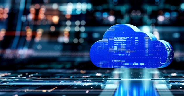 A digital 3D blue cloud floating in front of a large digital display out of focus in the background