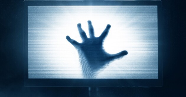 A screen displaying white static and a shadowy hand palm open